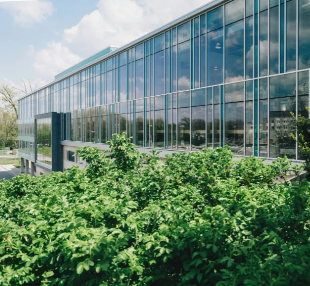 Extérieur d'un bâtiment moderne, avec de la verdure